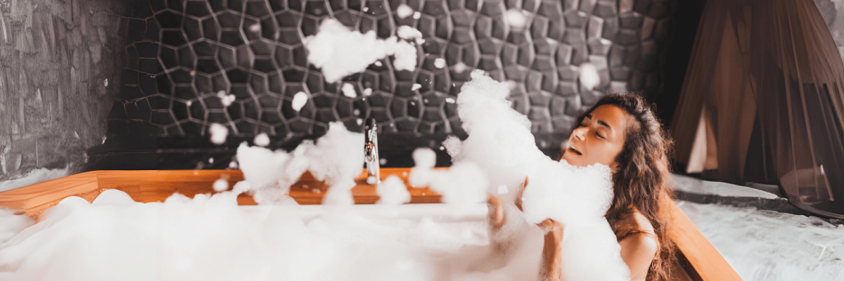 Frau in der Badewanne mit viel Badeschaum